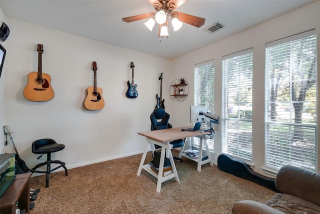 carpeted home office featuring ceiling fan and baseboards