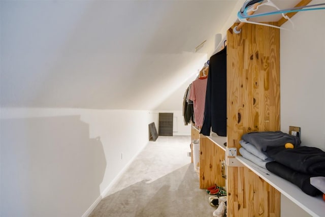 walk in closet featuring light carpet