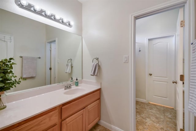 bathroom with vanity and baseboards
