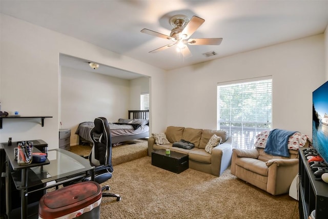 carpeted office space with ceiling fan