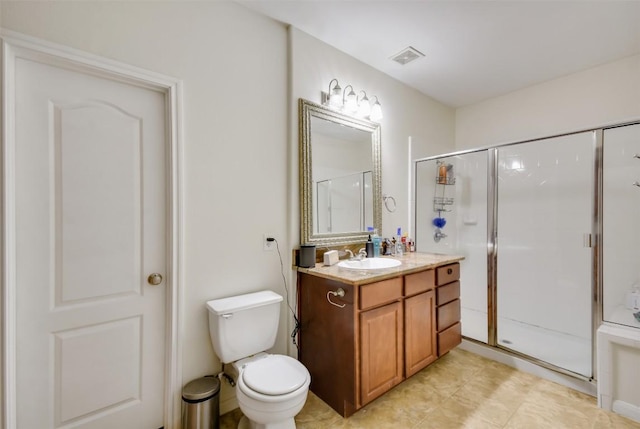 bathroom featuring a stall shower, vanity, toilet, and tile patterned flooring
