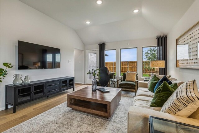 208 Hidalgo Ln, Elgin, TX 78621 - living room with lofted ceiling, wood finished floors, baseboards, and recessed lighting