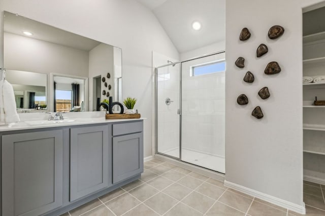 208 Hidalgo Ln, Elgin, TX 78621 - full bathroom featuring tiled shower, baseboards, vaulted ceiling, vanity, and tile patterned floors