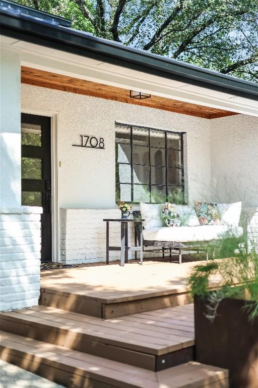 doorway to property featuring stucco siding