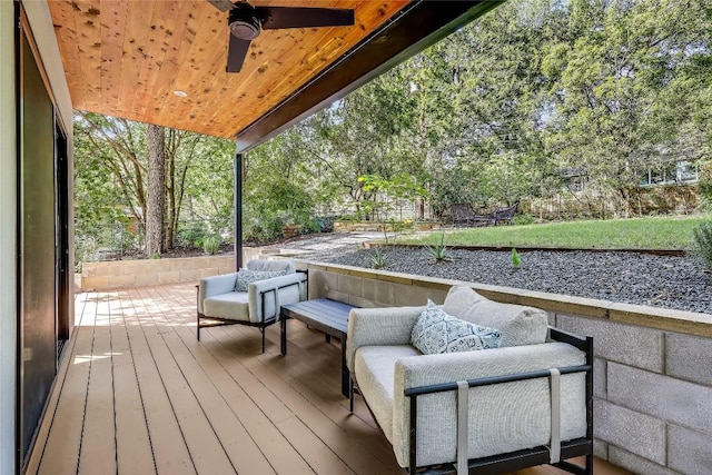 wooden deck featuring a ceiling fan