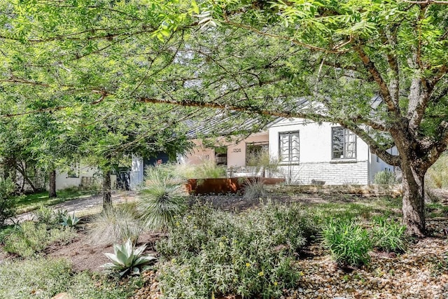 view of front of property with stucco siding and brick siding