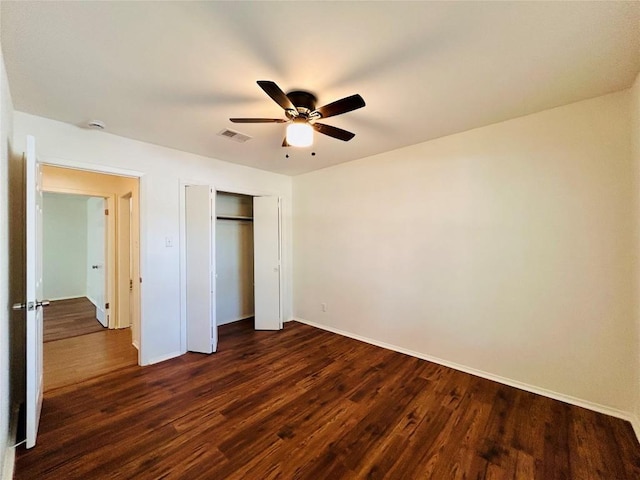 1906 Surrey Dr, Round Rock, TX 78664 - unfurnished bedroom with dark wood finished floors, baseboards, a closet, and a ceiling fan