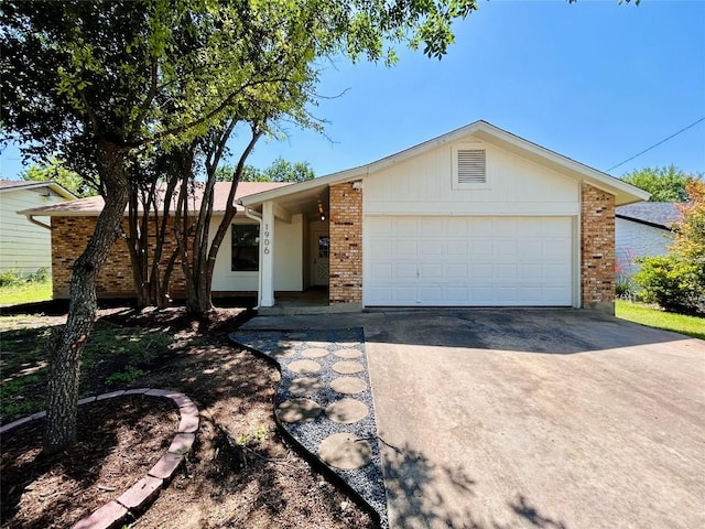 1906 Surrey Dr, Round Rock, TX 78664 - ranch-style home with concrete driveway, brick siding, and an attached garage
