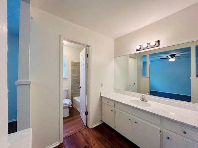 1906 Surrey Dr, Round Rock, TX 78664 - bathroom with toilet, wood finished floors, vanity, ceiling fan, and baseboards