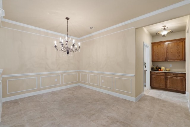 103 Nueces Trl, Georgetown, TX 78633 - unfurnished dining area featuring a decorative wall, a chandelier, ornamental molding, and a wainscoted wall