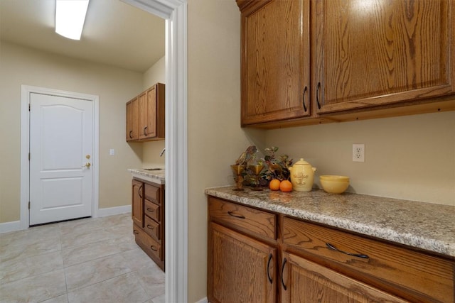 103 Nueces Trl, Georgetown, TX 78633 - clothes washing area featuring baseboards and light tile patterned flooring