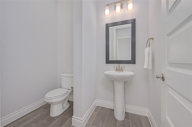 6108 Antelope Well Ln, Austin, TX 78738 - bathroom with toilet, baseboards, and wood finish floors
