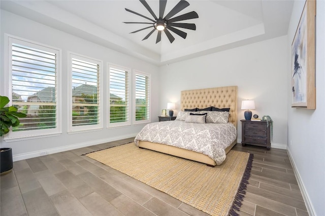6108 Antelope Well Ln, Austin, TX 78738 - bedroom with a tray ceiling, baseboards, wood finished floors, and ceiling fan