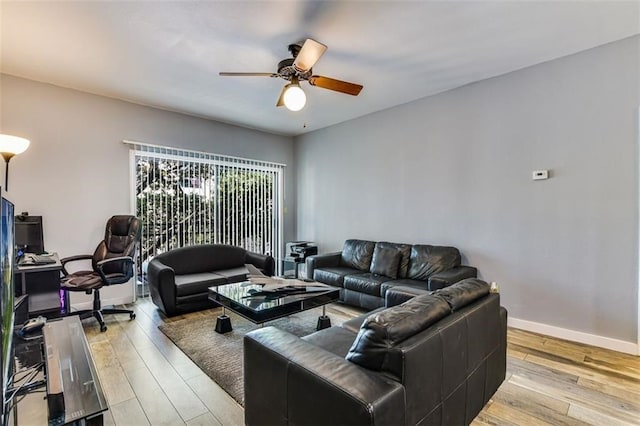 1908 San Antonio St Unit 213, Austin, TX 78705 - living room with ceiling fan, light wood-style floors, and baseboards