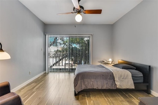 1908 San Antonio St Unit 213, Austin, TX 78705 - bedroom featuring wood finished floors, baseboards, a ceiling fan, and access to outside