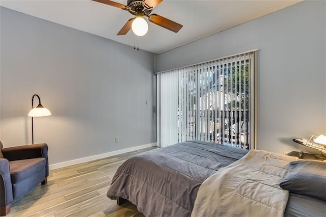 1908 San Antonio St Unit 213, Austin, TX 78705 - bedroom with wood finished floors, baseboards, and a ceiling fan