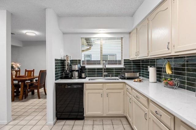 4210 Harcourt Dr, Austin, TX 78727 - kitchen with black dishwasher, a sink, light tile patterned floors, a textured ceiling, and decorative backsplash