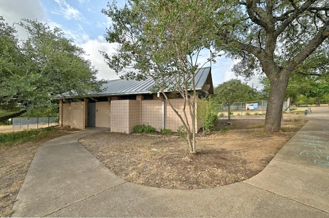 4210 Harcourt Dr, Austin, TX 78727 - view of home's exterior featuring fence, metal roof, and a standing seam roof