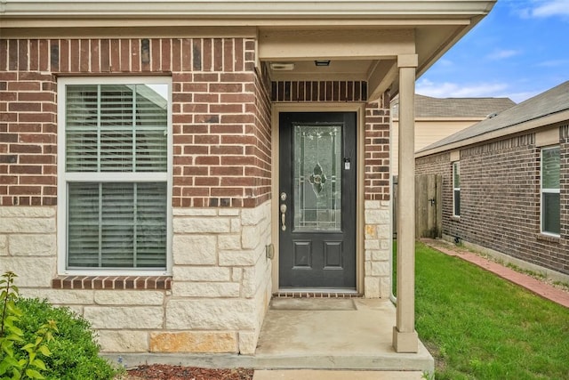 entrance to property with brick siding and stone siding