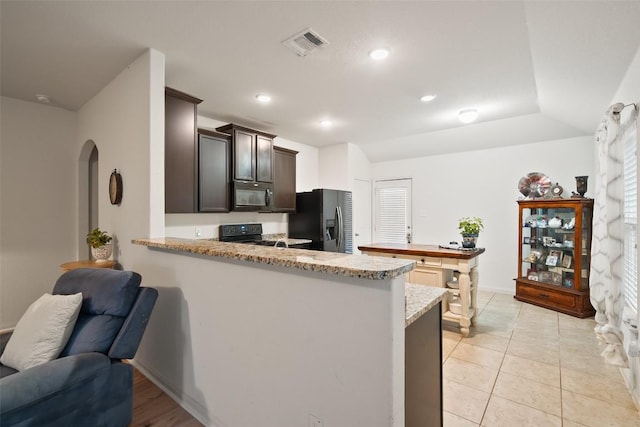 kitchen featuring black appliances, arched walkways, light stone countertops, a peninsula, and recessed lighting