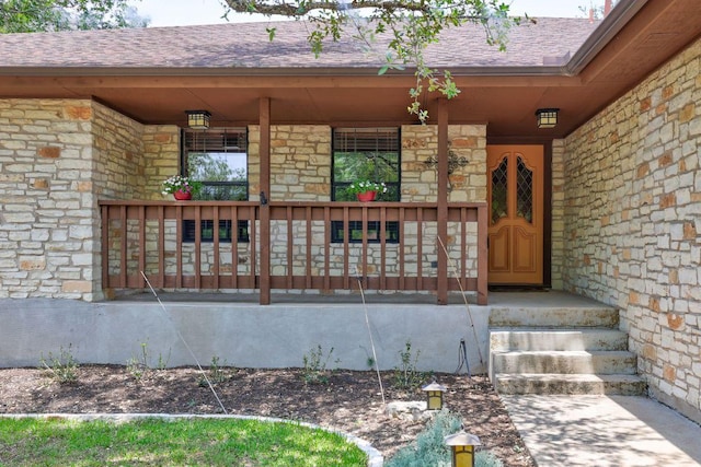 10804 Buckthorn Dr, Austin, TX 78759 - doorway to property featuring stone siding, a porch, and a shingled roof