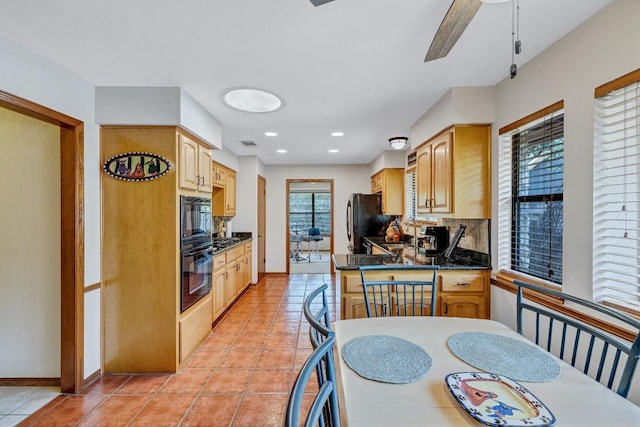 10804 Buckthorn Dr, Austin, TX 78759 - kitchen featuring freestanding refrigerator, decorative backsplash, dark countertops, stainless steel gas stovetop, and light tile patterned floors