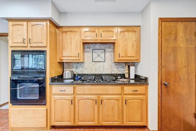 10804 Buckthorn Dr, Austin, TX 78759 - kitchen with dark stone counters, decorative backsplash, stainless steel gas cooktop, light brown cabinets, and light tile patterned floors