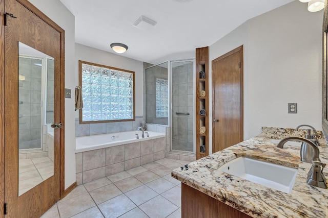 10804 Buckthorn Dr, Austin, TX 78759 - full bathroom featuring double vanity, a stall shower, a bath, and tile patterned flooring