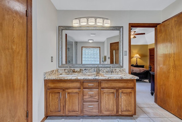 10804 Buckthorn Dr, Austin, TX 78759 - bathroom with double vanity, ensuite bath, tile patterned floors, and ceiling fan
