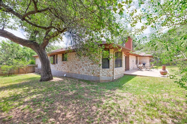 10804 Buckthorn Dr, Austin, TX 78759 - rear view of property featuring a chimney, stone siding, and a patio area