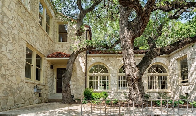 806 Rosedale Ter, Austin, TX 78704 - view of exterior entry featuring stone siding and fence