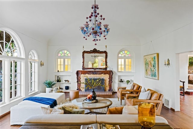 806 Rosedale Ter, Austin, TX 78704 - living room with plenty of natural light, wood finished floors, vaulted ceiling, and a fireplace with raised hearth