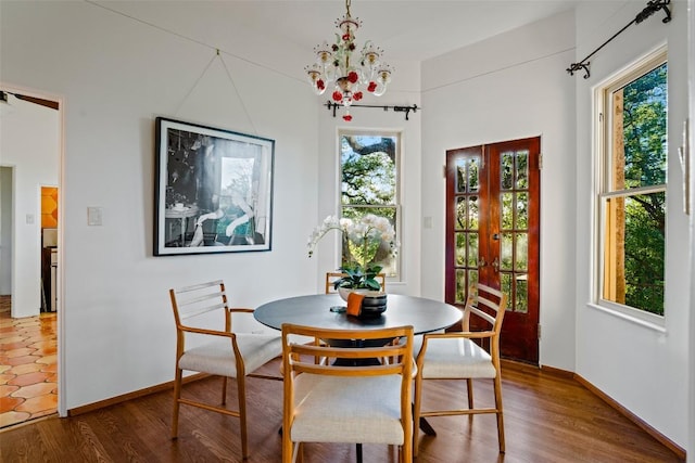 806 Rosedale Ter, Austin, TX 78704 - dining space featuring a chandelier, wood finished floors, and baseboards