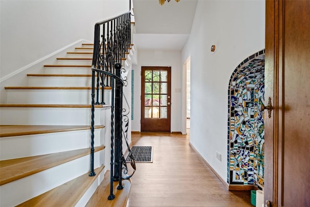 806 Rosedale Ter, Austin, TX 78704 - foyer with wood finished floors, stairway, arched walkways, and baseboards