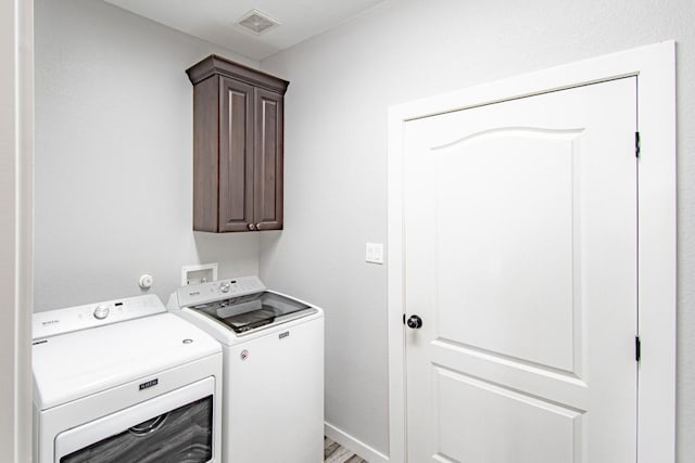 121 Grassy Ln, Elgin, TX 78621 - laundry room featuring washer and dryer and cabinet space