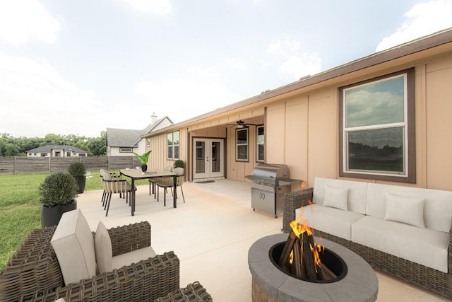 121 Grassy Ln, Elgin, TX 78621 - view of patio featuring french doors, an outdoor living space with a fire pit, outdoor dining area, an outdoor kitchen, and ceiling fan
