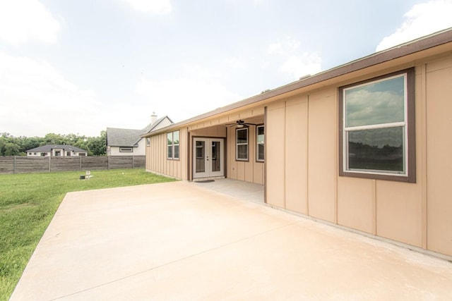 121 Grassy Ln, Elgin, TX 78621 - back of house with board and batten siding, french doors, a patio, and ceiling fan