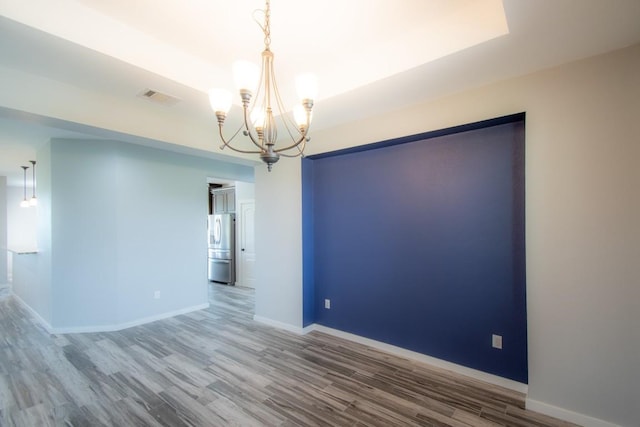 121 Grassy Ln, Elgin, TX 78621 - spare room featuring a chandelier and wood finished floors