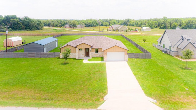 121 Grassy Ln, Elgin, TX 78621 - view of front of house with board and batten siding, a garage, driveway, and stone siding