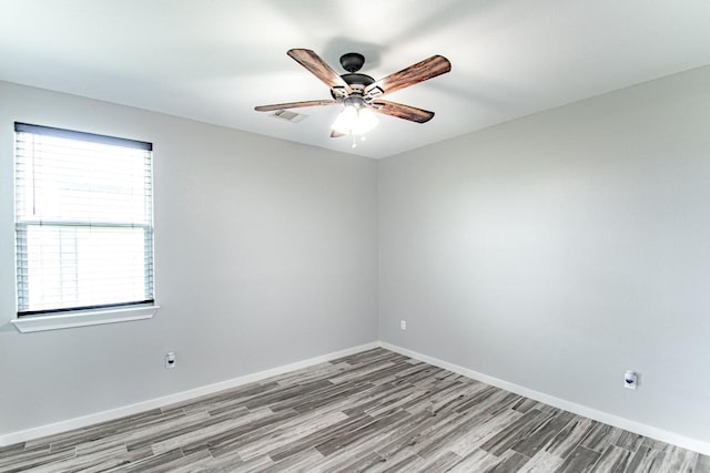 121 Grassy Ln, Elgin, TX 78621 - spare room featuring wood finished floors and ceiling fan
