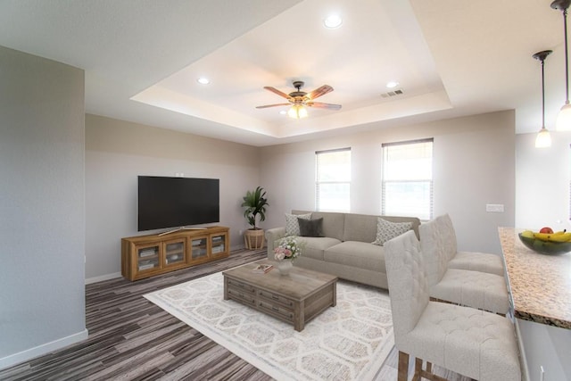 121 Grassy Ln, Elgin, TX 78621 - living room with a raised ceiling, wood finished floors, a ceiling fan, and recessed lighting
