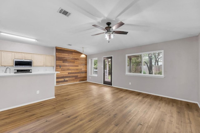906 Mammoth Ct, Round Rock, TX 78681 - unfurnished living room featuring vaulted ceiling, wood finished floors, ceiling fan, and baseboards