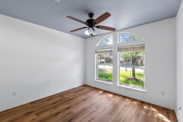 906 Mammoth Ct, Round Rock, TX 78681 - spare room with wood finished floors, a ceiling fan, and baseboards