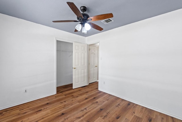 906 Mammoth Ct, Round Rock, TX 78681 - unfurnished bedroom featuring baseboards, wood finished floors, a closet, and a ceiling fan