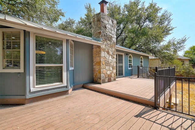 wooden terrace featuring fence