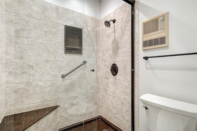 full bathroom with toilet and a shower stall