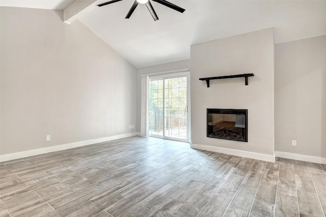 unfurnished living room with a ceiling fan, wood finished floors, a glass covered fireplace, and baseboards