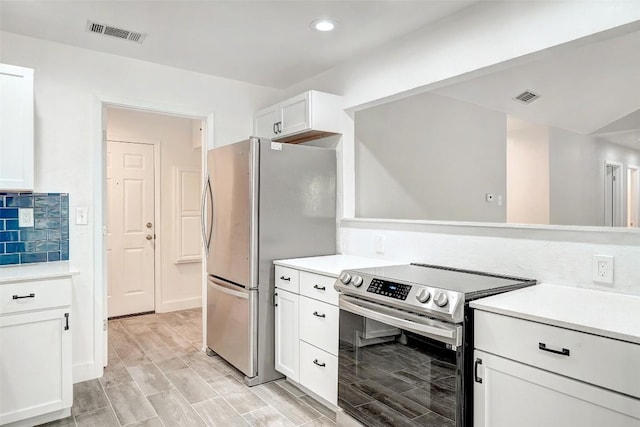 kitchen with stainless steel appliances, white cabinetry, light countertops, recessed lighting, and wood tiled floors