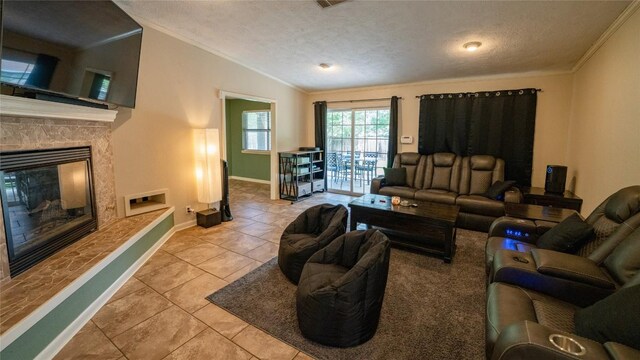 living area with tile patterned floors, a textured ceiling, lofted ceiling, crown molding, and baseboards