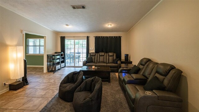living room with crown molding, baseboards, light tile patterned flooring, and a textured ceiling